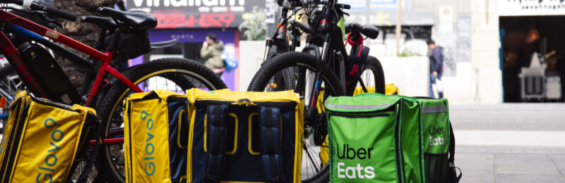 Barcelona, Spain – April 09, 2022: A bunch of delivery boxes placed on the ground near bikes waiting for delivery to customers, Barcelona, Spain Wirestock